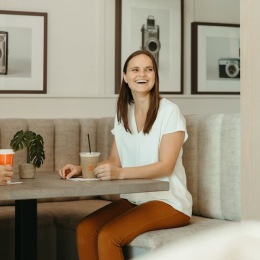 a woman smiling in a chair