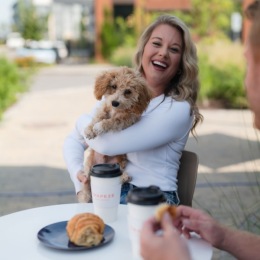 a woman holding a dog