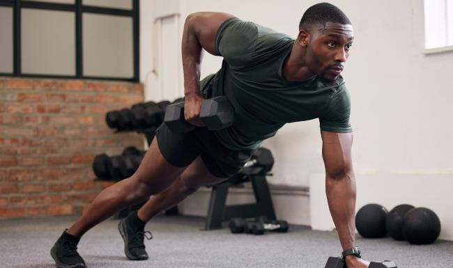 a person squatting on a bench with weights
