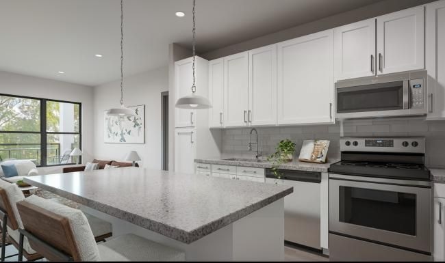 a kitchen with white cabinets
